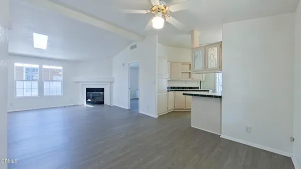 a view of kitchen with wooden floor electronic appliances and window