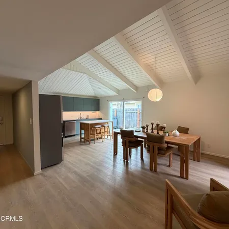 a dining room with furniture and wooden floor