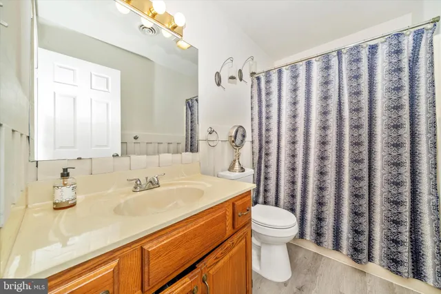 a bathroom with a sink toilet and a mirror