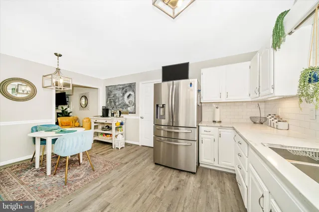 a view of dining room and kitchen with furniture and a chandelier