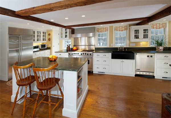 42 Topsfield Road Boxford, MA 01921 - Photo 4 of 30 a kitchen with stainless steel appliances a stove a sink a microwave a dining table and chairs