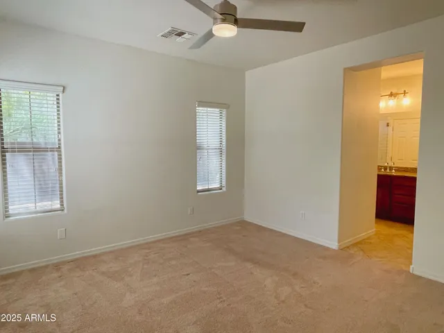 an empty room with windows and closet