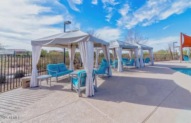 a view of a porch with a table and chairs
