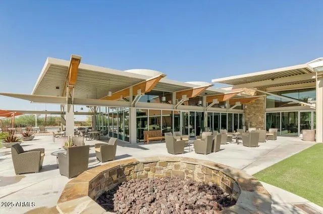 a view of a house with backyard porch and sitting area