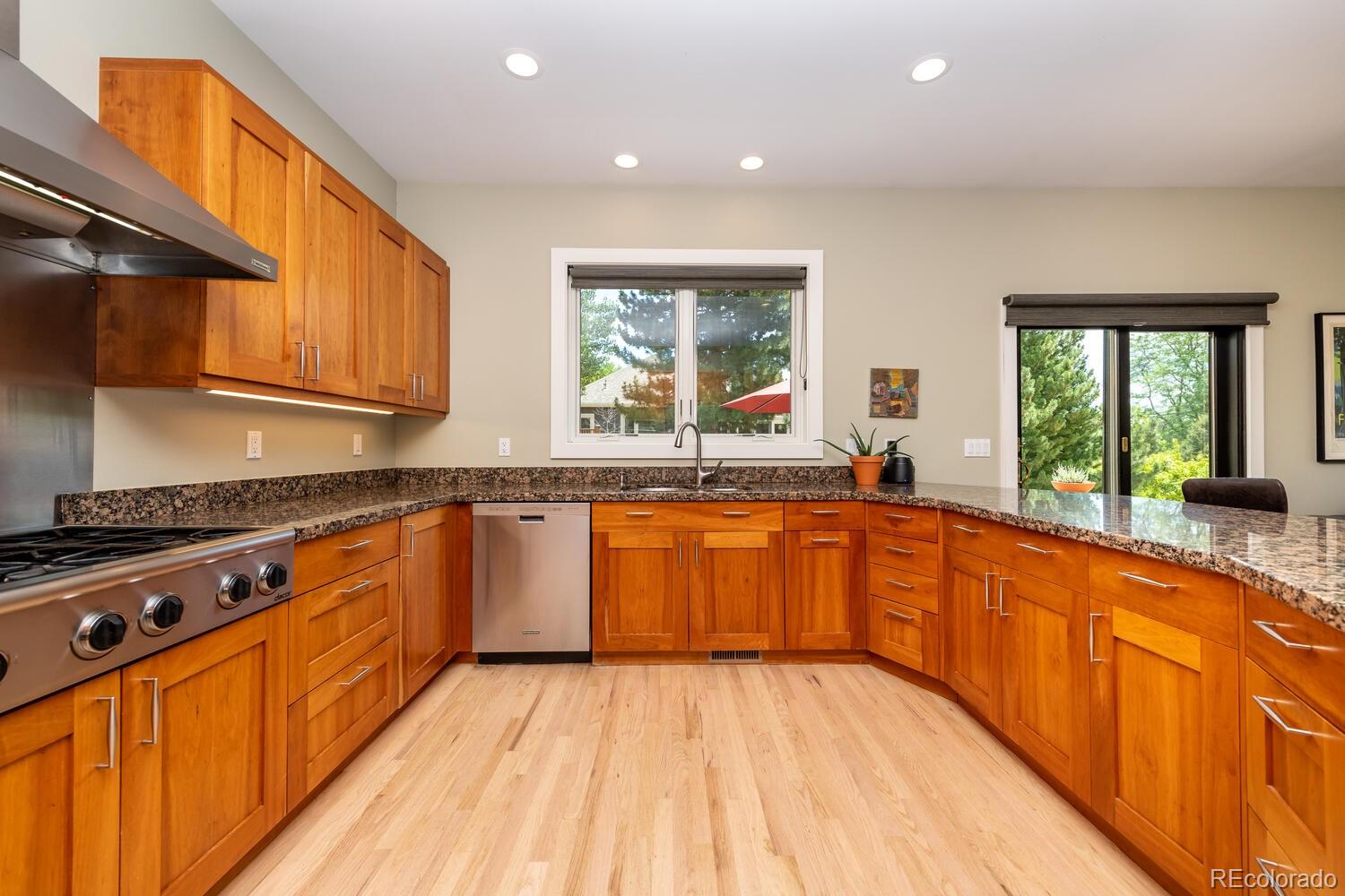3828 Cloverleaf Drive Boulder, CO 80304 - Photo 11 of 40 a large kitchen with stainless steel appliances granite countertop a stove a sink dishwasher and cabinets with wooden floor