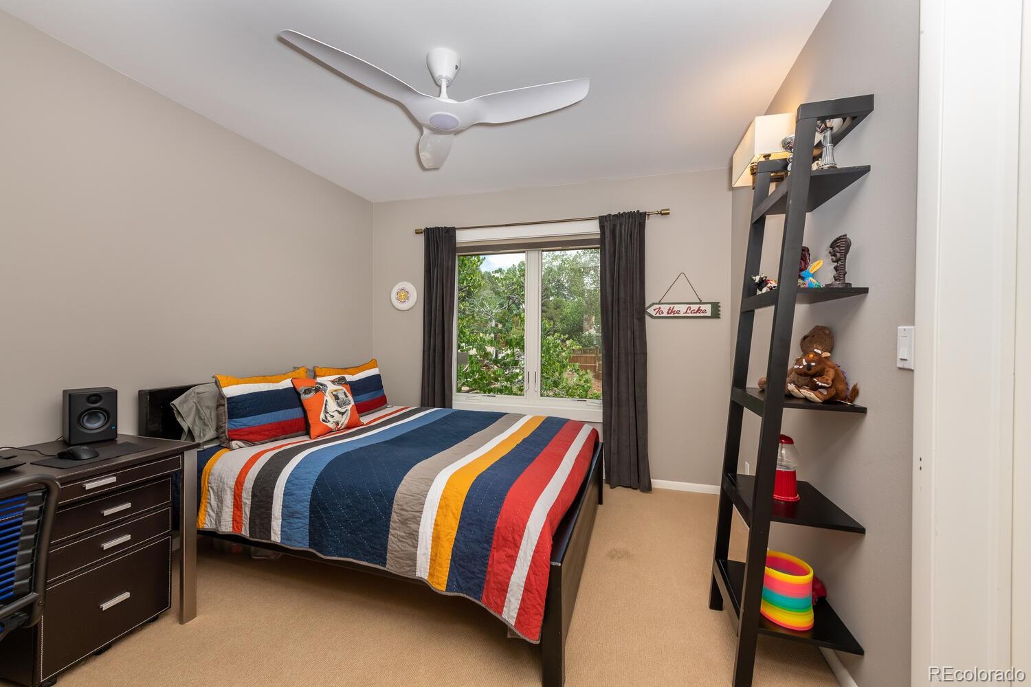 3828 Cloverleaf Drive Boulder, CO 80304 - Photo 20 of 40 a bedroom with a bed and a chandelier