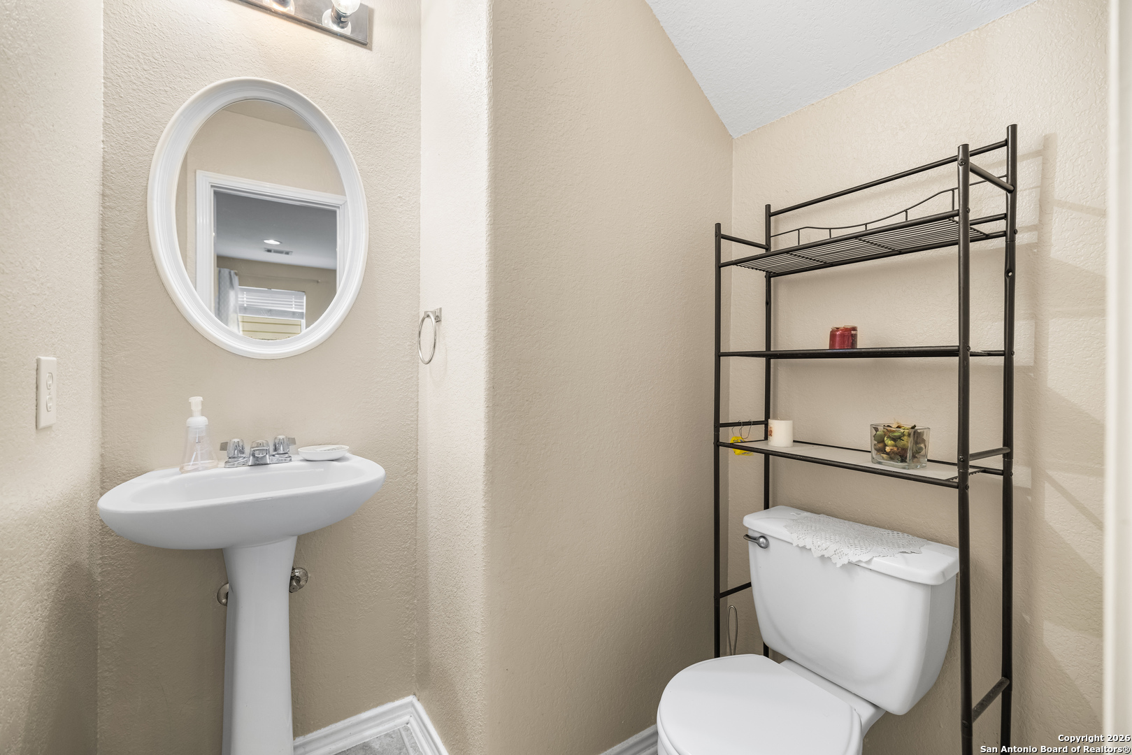 6522 Charles Field Leon Valley, TX 78238 - Photo 13 of 30 a bathroom with a toilet sink and mirror