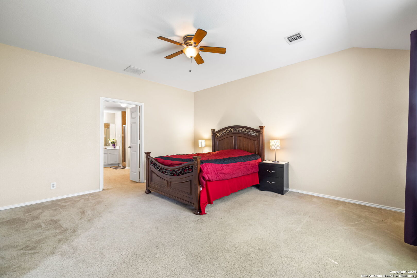 6522 Charles Field Leon Valley, TX 78238 - Photo 15 of 30 a room with a bed and a chandelier