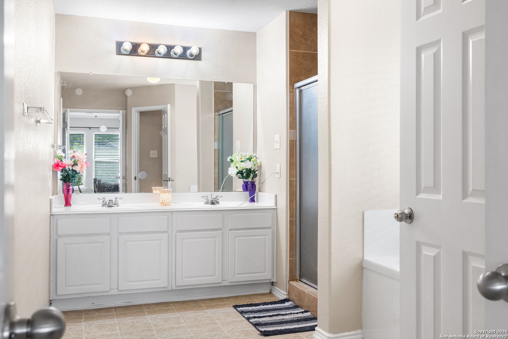 6522 Charles Field Leon Valley, TX 78238 - Photo 16 of 30 a bathroom with a sink and a mirror