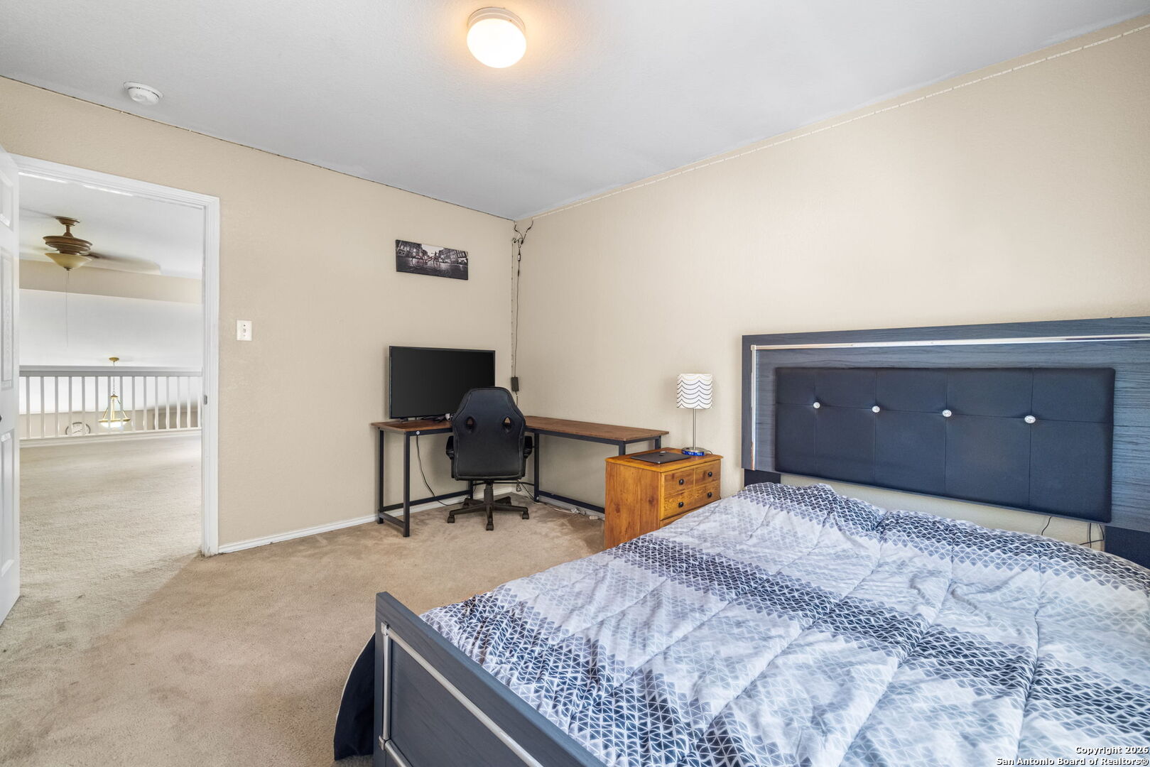 6522 Charles Field Leon Valley, TX 78238 - Photo 24 of 30 a bedroom with a bed and chair