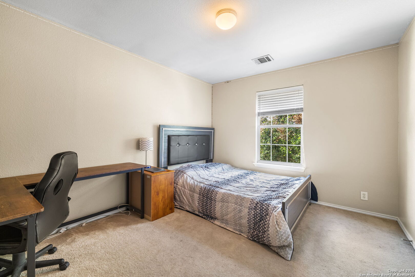 6522 Charles Field Leon Valley, TX 78238 - Photo 25 of 30 a bedroom with bed and a window