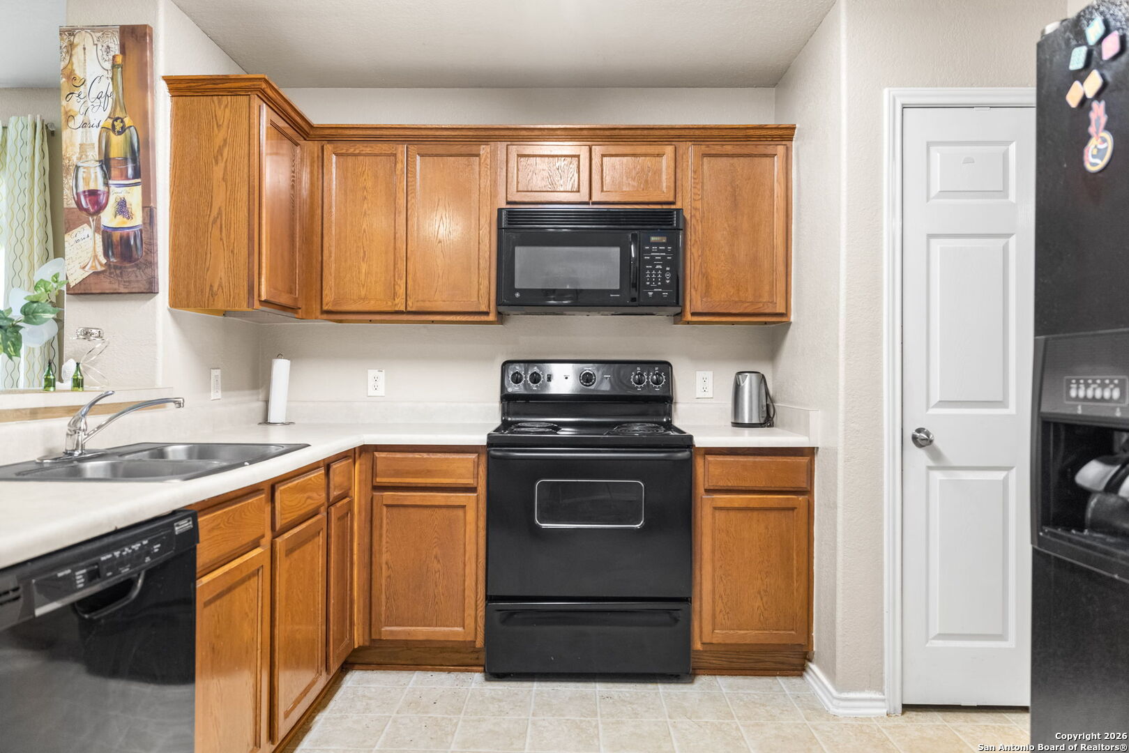 6522 Charles Field Leon Valley, TX 78238 - Photo 7 of 30 a kitchen with a sink stove and microwave