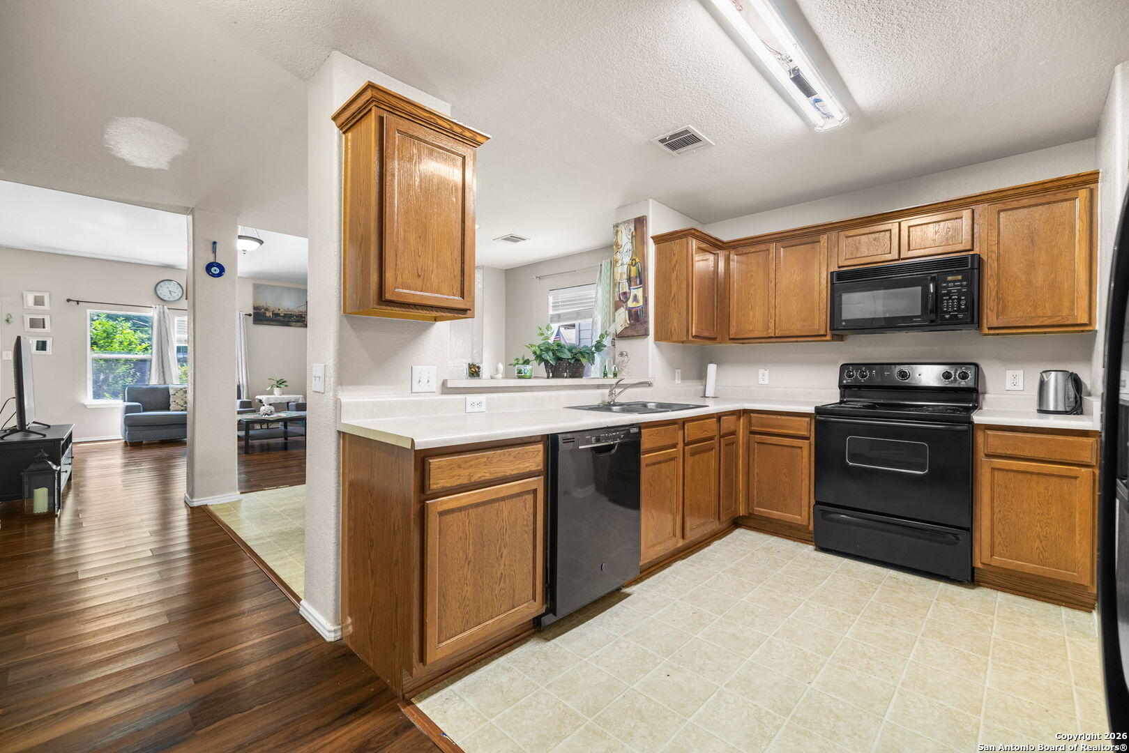 6522 Charles Field Leon Valley, TX 78238 - Photo 8 of 30 a kitchen with a sink stove and microwave