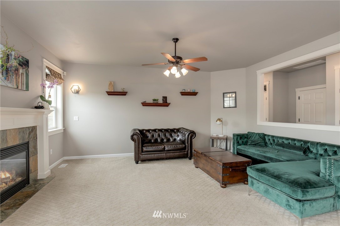 5805 Parker Road East Sumner, WA 98390 - Photo 23 of 40 a living room with furniture and a fireplace