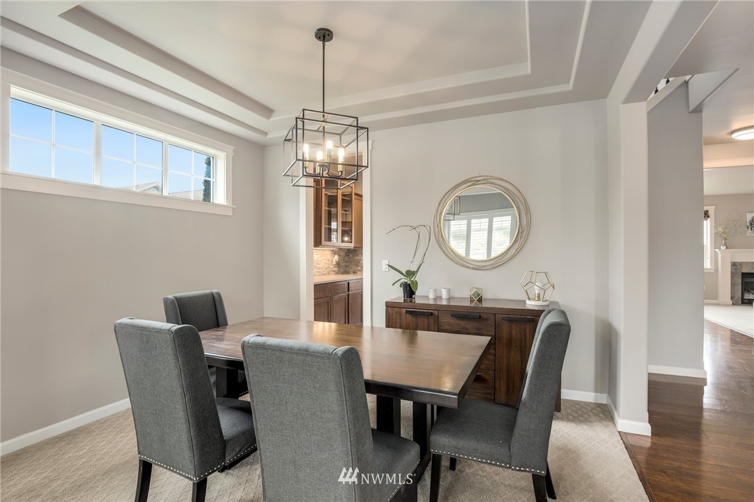 5805 Parker Road East Sumner, WA 98390 - Photo 8 of 40 a view of a dining room with furniture a chandelier and wooden floor