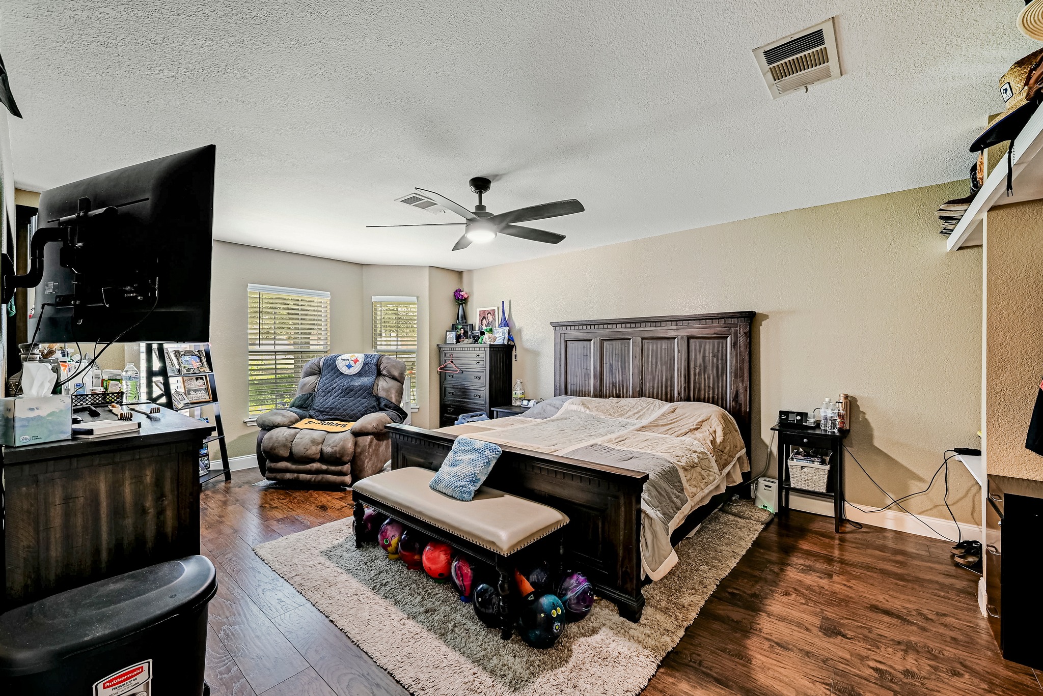104 North Sumac Lane Georgetown, TX 78633 - Photo 8 of 40 Wood flooring and a ceiling fan enhance comfort in this well-appointed bedroom retreat.