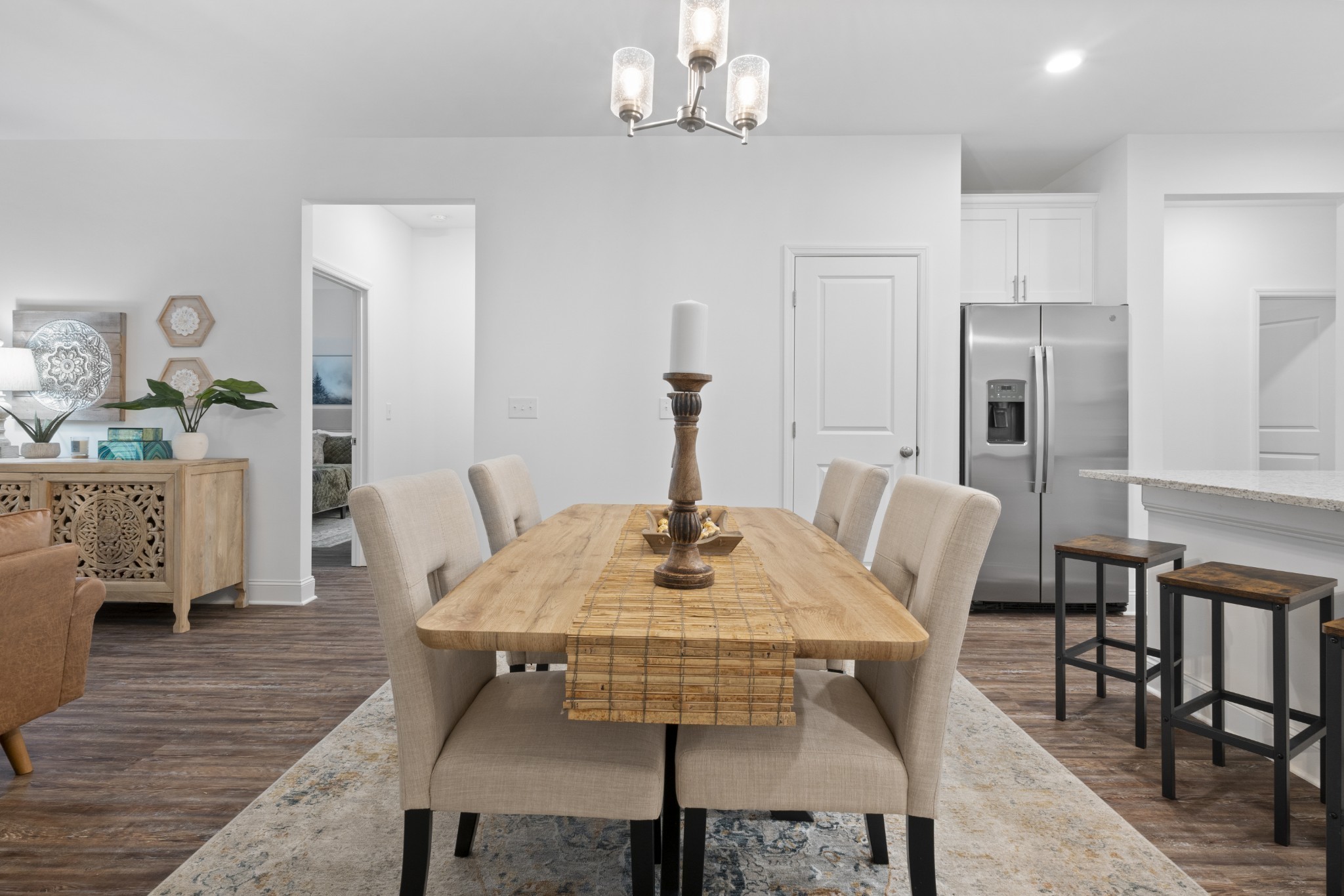 12003 Mdw Pl Lane, Unit 12003 Madison, AL 35757 - Photo 5 of 11 a view of a dining room with furniture and wooden floor