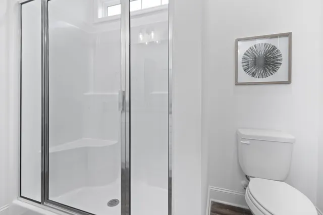 a white toilet sitting next to a bathroom sink