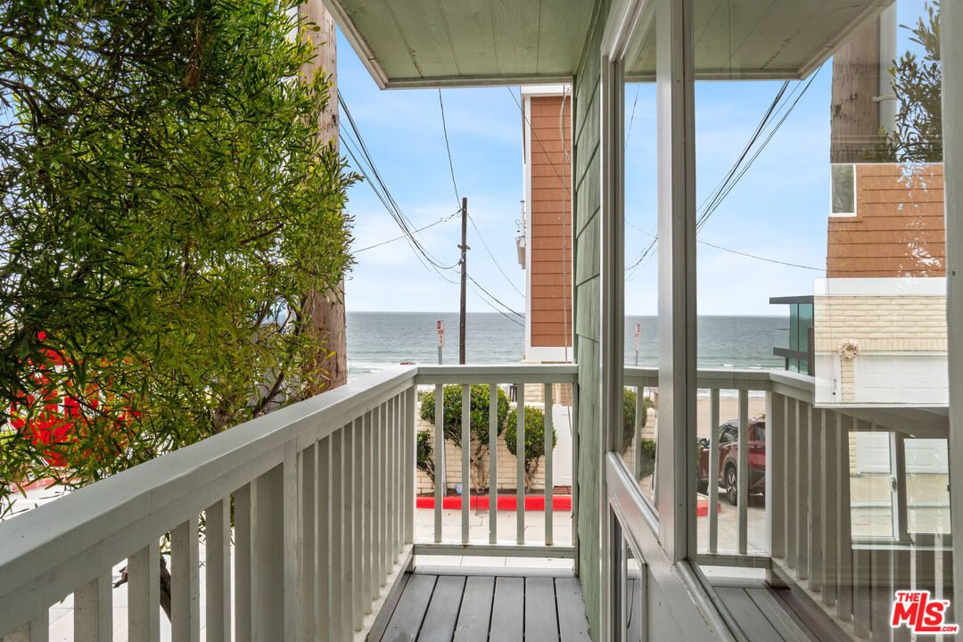 a view of a balcony with wooden floor