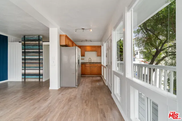 a view of a hallway with wooden floors and stairs