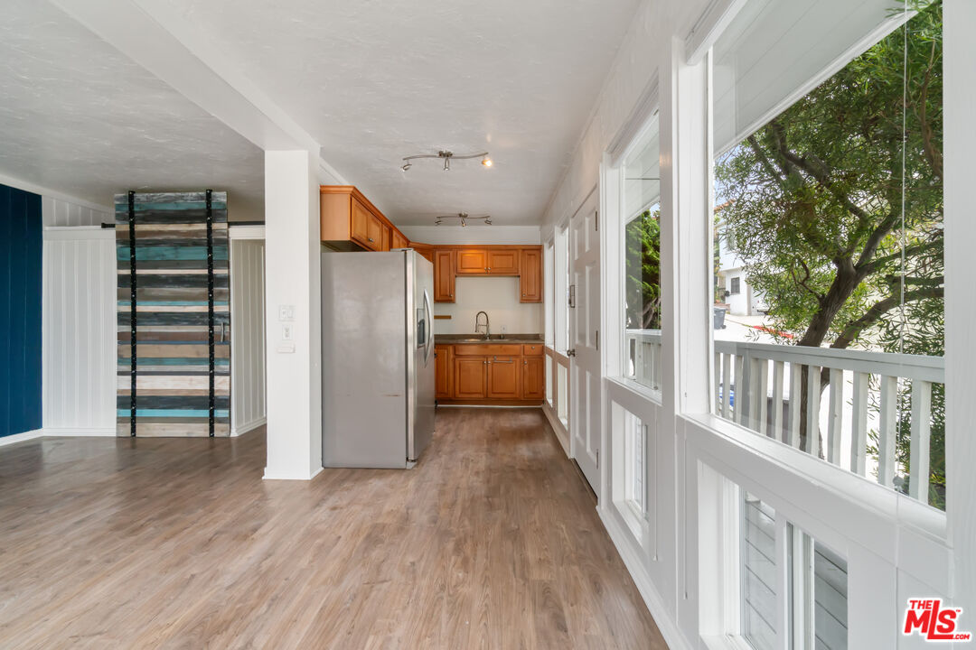 115 44th Street Manhattan Beach, CA 90266 - Photo 13 of 38 a view of a hallway with wooden floors and stairs