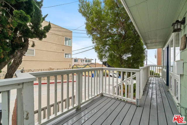 a view of balcony with wooden floor and fence
