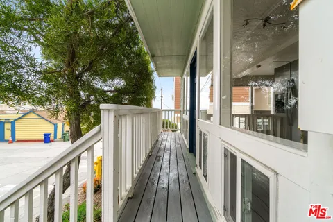 a view of balcony with wooden floor and outdoor seating