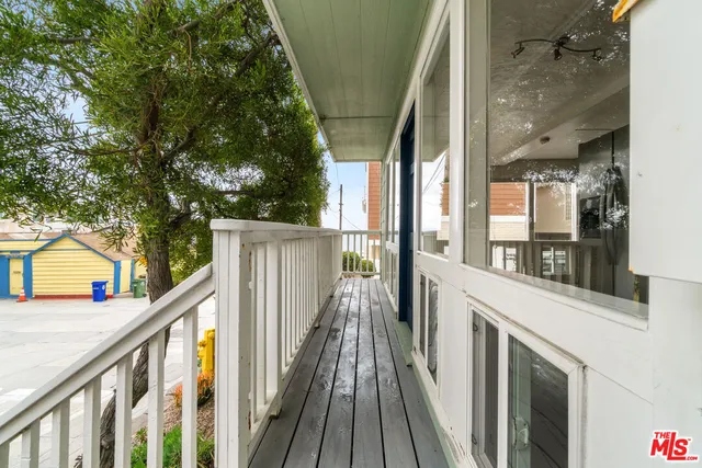 a view of balcony with wooden floor and outdoor seating