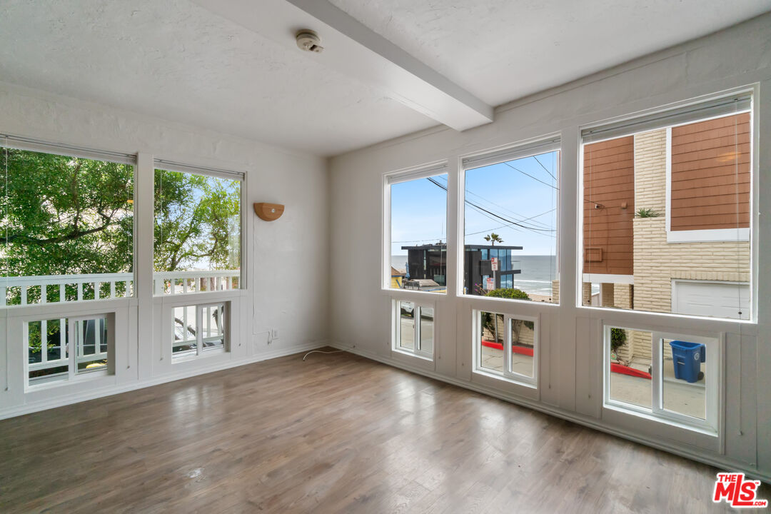115 44th Street Manhattan Beach, CA 90266 - Photo 6 of 38 a kitchen with stainless steel appliances granite countertop a stove and a large window