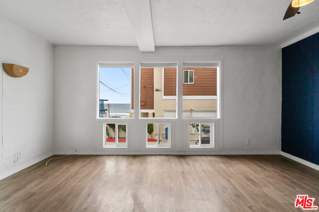 115 44th Street Manhattan Beach, CA 90266 - Photo 9 of 38 a view of an empty room with window and wooden floor