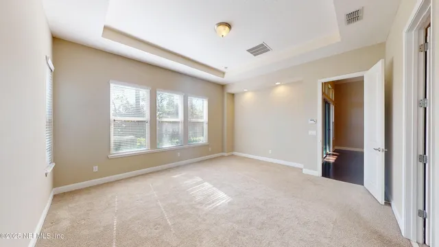 an empty room with windows and closet