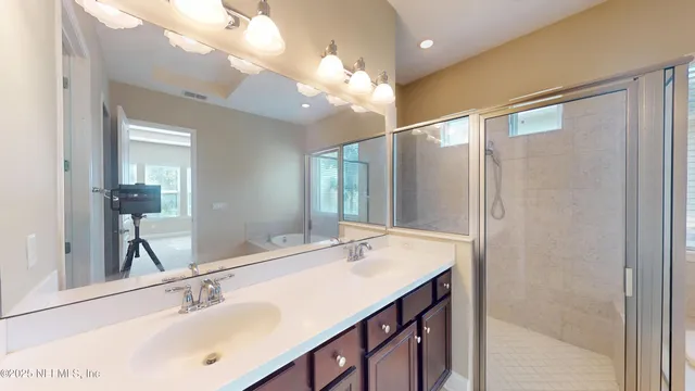 a bathroom with a sink double vanity and a mirror
