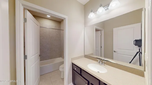 a bathroom with a sink vanity tub and a mirror