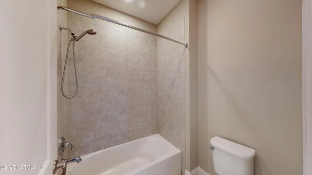 a bathroom with a shower and a toilet