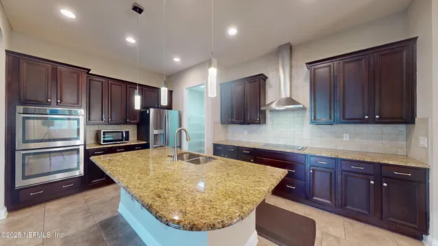 a kitchen with wooden cabinets and stainless steel appliances