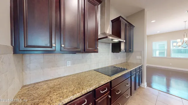 a kitchen with stainless steel appliances granite countertop a sink stove and microwave