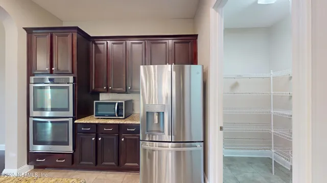 a kitchen with kitchen island wooden cabinets and stainless steel appliances