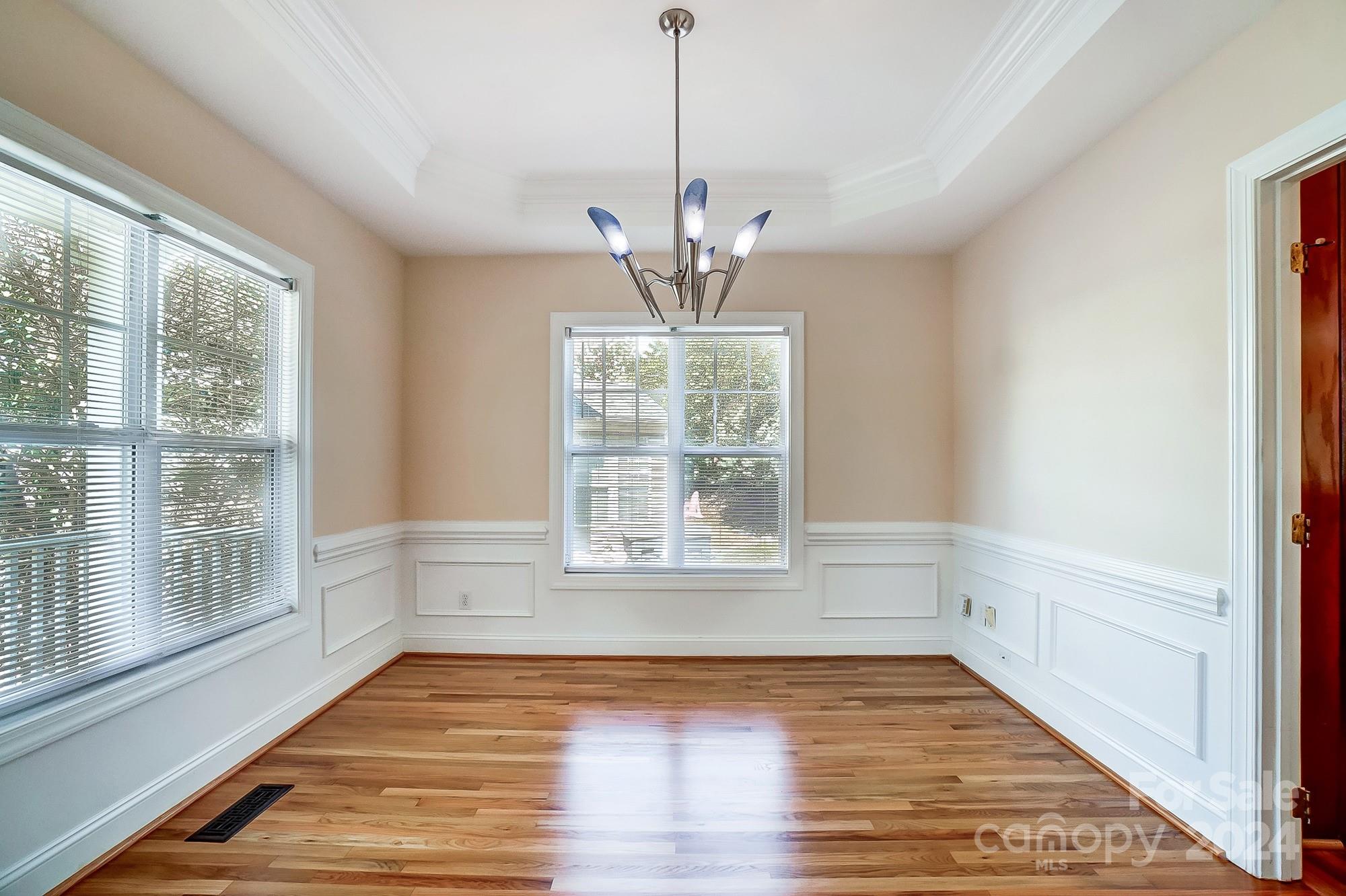 14137 Wild Elm Road Charlotte, NC 28277 - Photo 15 of 36 a view of an empty room with wooden floor and a window