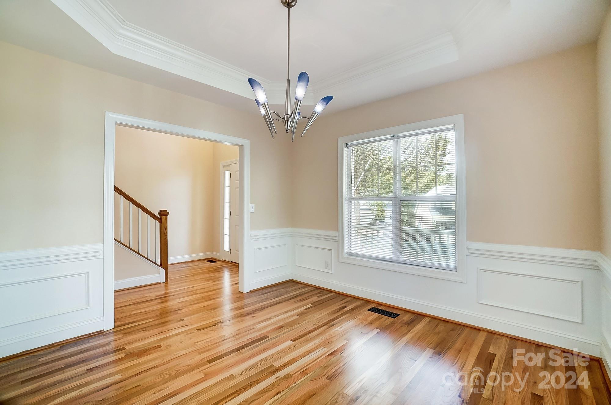 14137 Wild Elm Road Charlotte, NC 28277 - Photo 16 of 36 a view of an empty room with wooden floor and a window