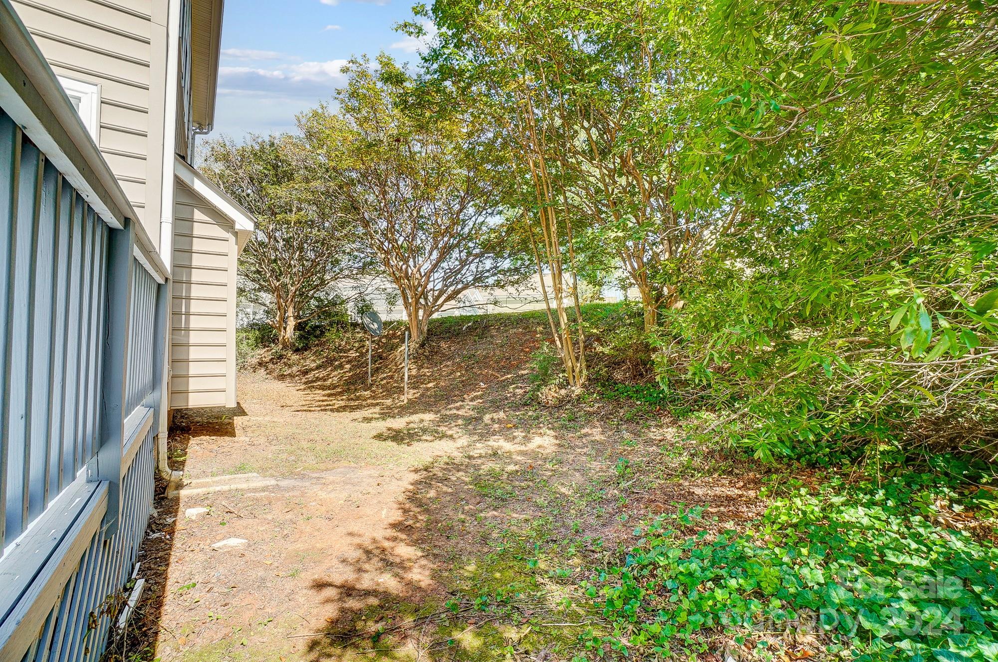 14137 Wild Elm Road Charlotte, NC 28277 - Photo 36 of 36 a backyard of a house with large trees