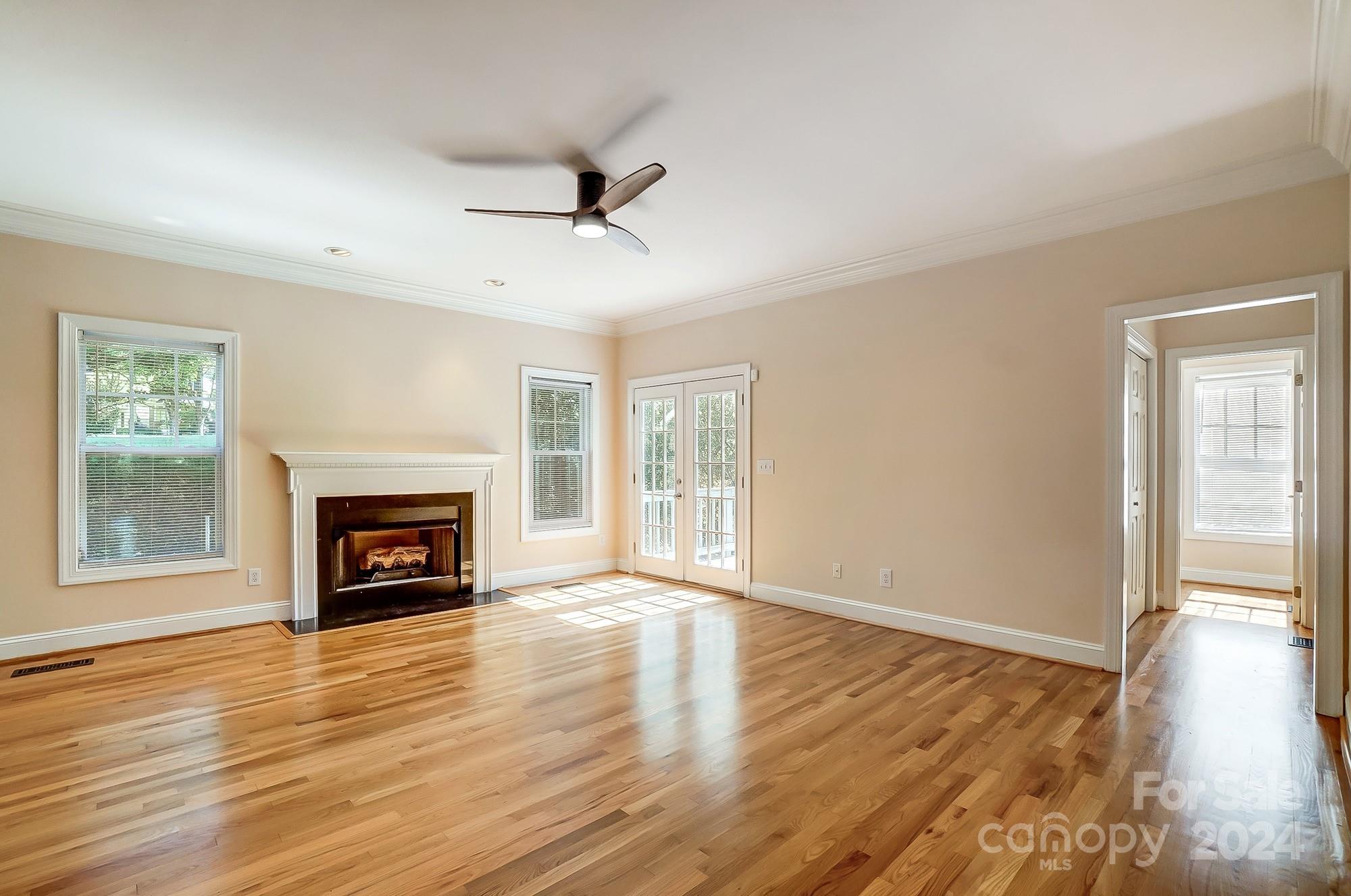 14137 Wild Elm Road Charlotte, NC 28277 - Photo 5 of 36 a view of main area fire place window and wooden floor