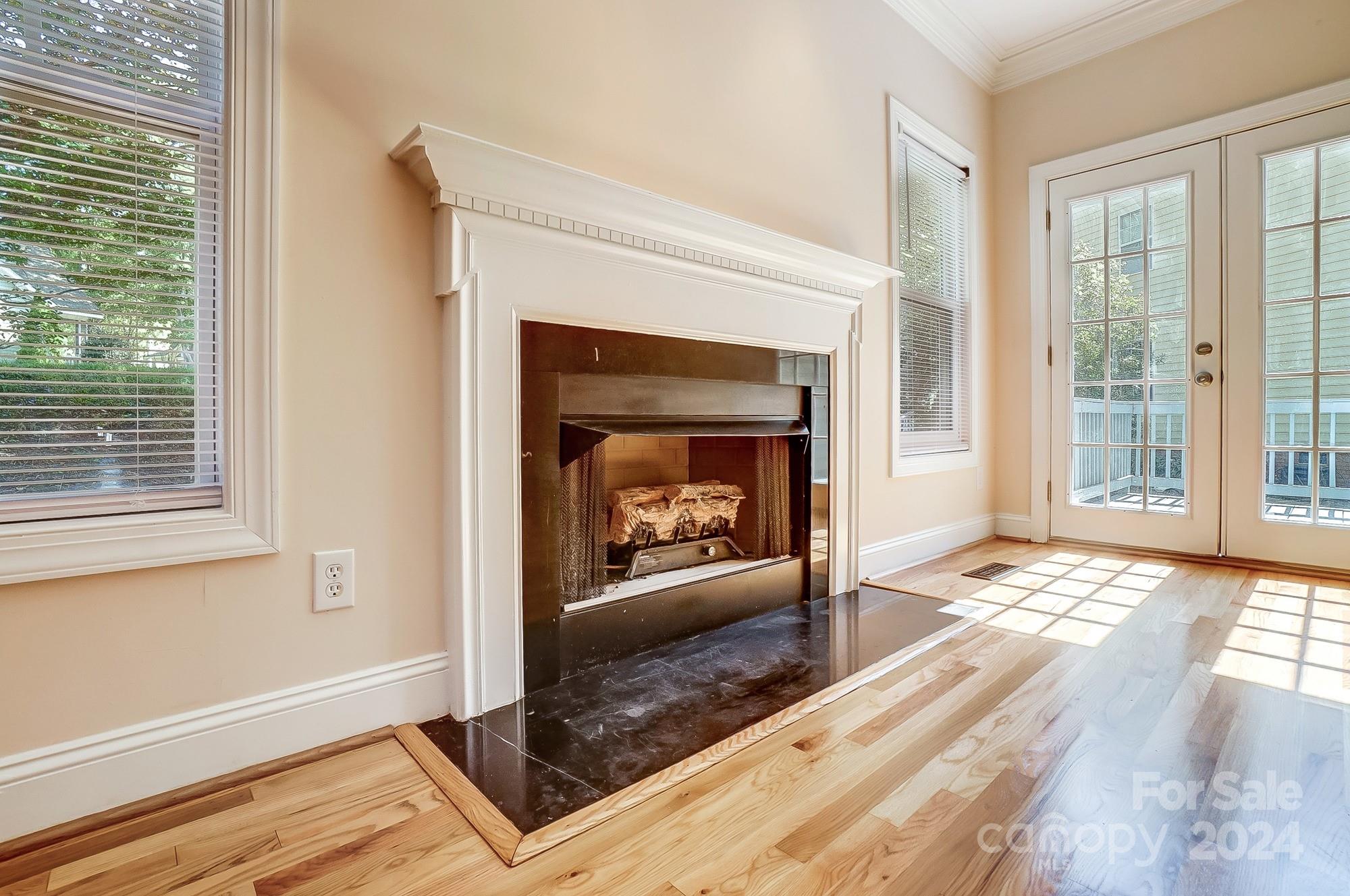 14137 Wild Elm Road Charlotte, NC 28277 - Photo 7 of 36 a living room with a fireplace and a floor to ceiling window