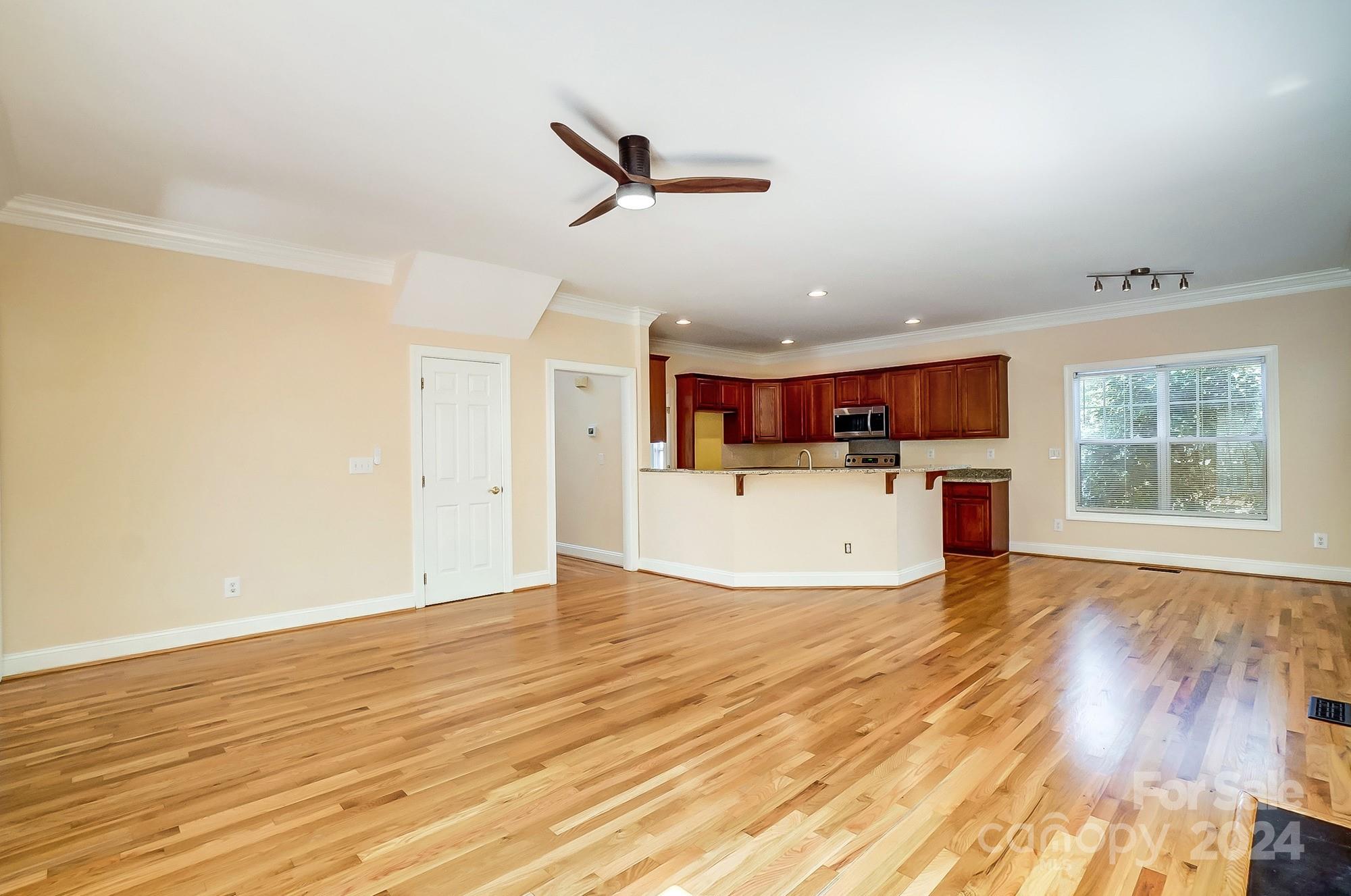 14137 Wild Elm Road Charlotte, NC 28277 - Photo 8 of 36 a view of kitchen with wooden floor and window