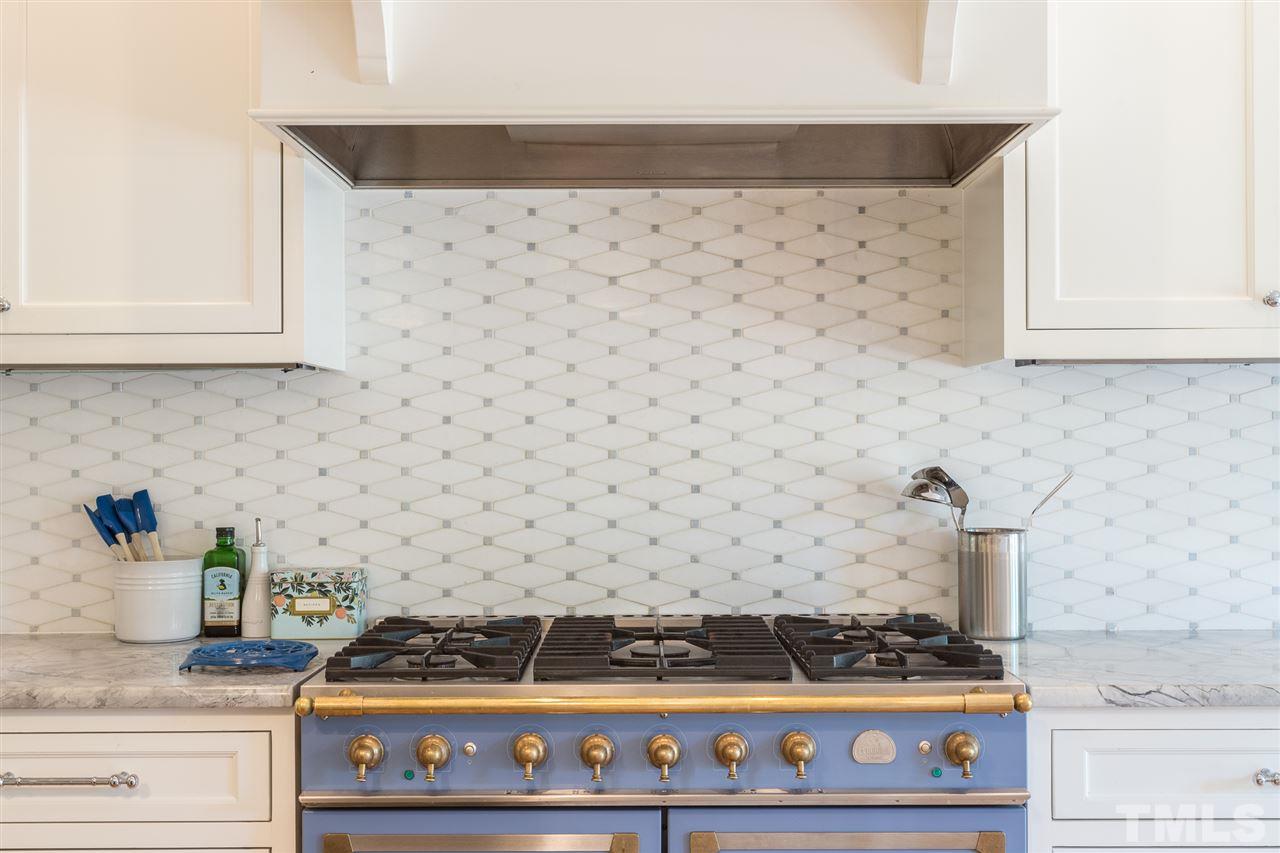 1424 Canterbury Road Raleigh, NC 27608 - Photo 12 of 29 a kitchen with a stove and cabinets