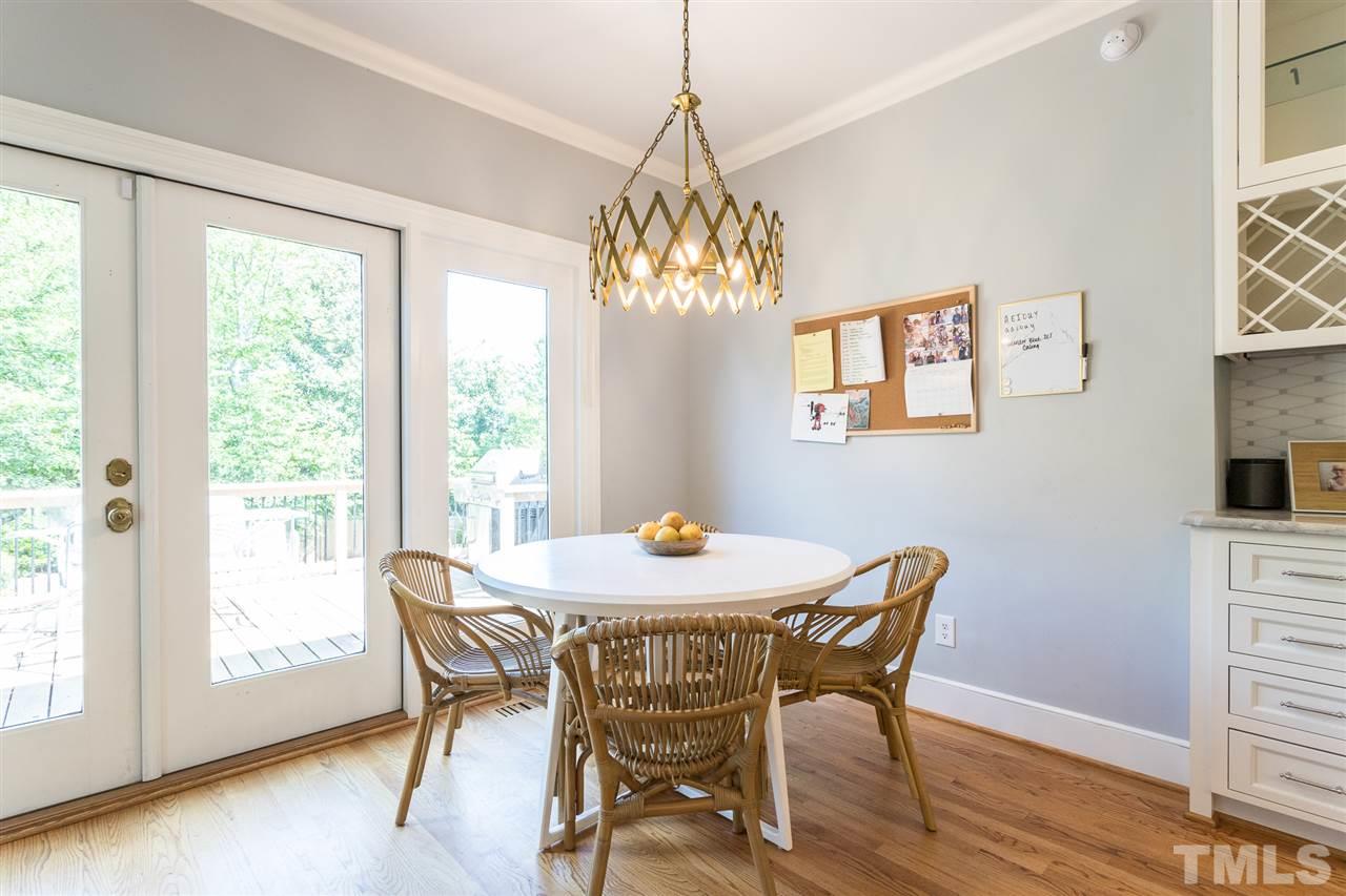 1424 Canterbury Road Raleigh, NC 27608 - Photo 15 of 29 a dining room with furniture a window and wooden floor