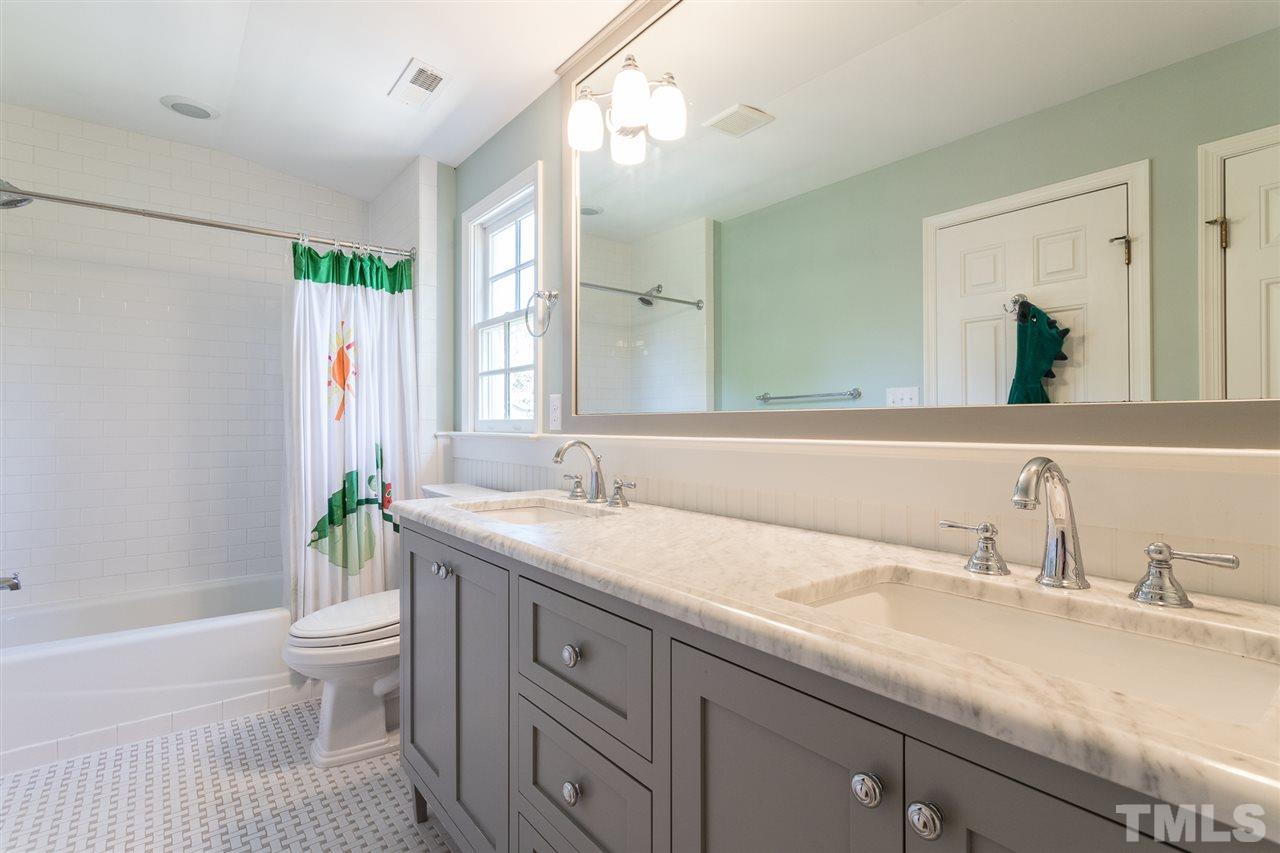 1424 Canterbury Road Raleigh, NC 27608 - Photo 18 of 29 a bathroom with a granite countertop sink a toilet and a mirror