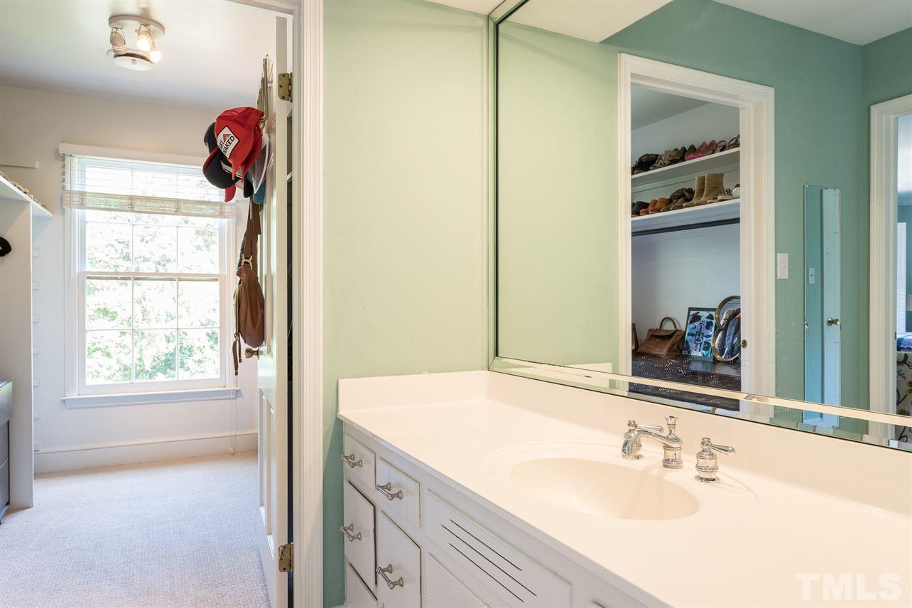 1424 Canterbury Road Raleigh, NC 27608 - Photo 20 of 29 a bathroom with a sink mirror and vanity