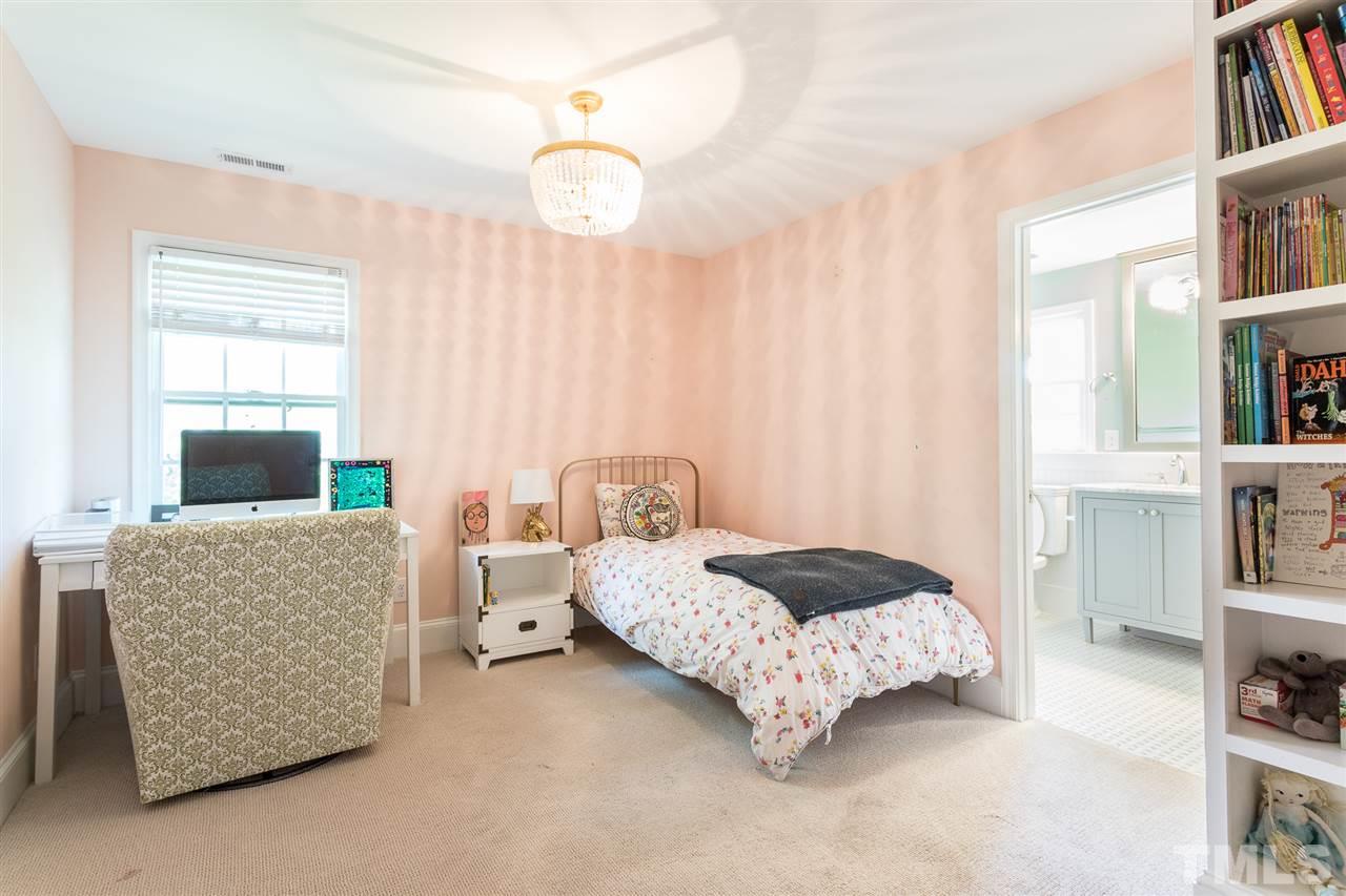 1424 Canterbury Road Raleigh, NC 27608 - Photo 23 of 29 a bedroom with bed and a book shelf