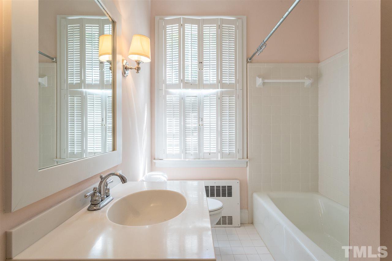 1424 Canterbury Road Raleigh, NC 27608 - Photo 24 of 29 a bathroom with sink granite tub and a mirror