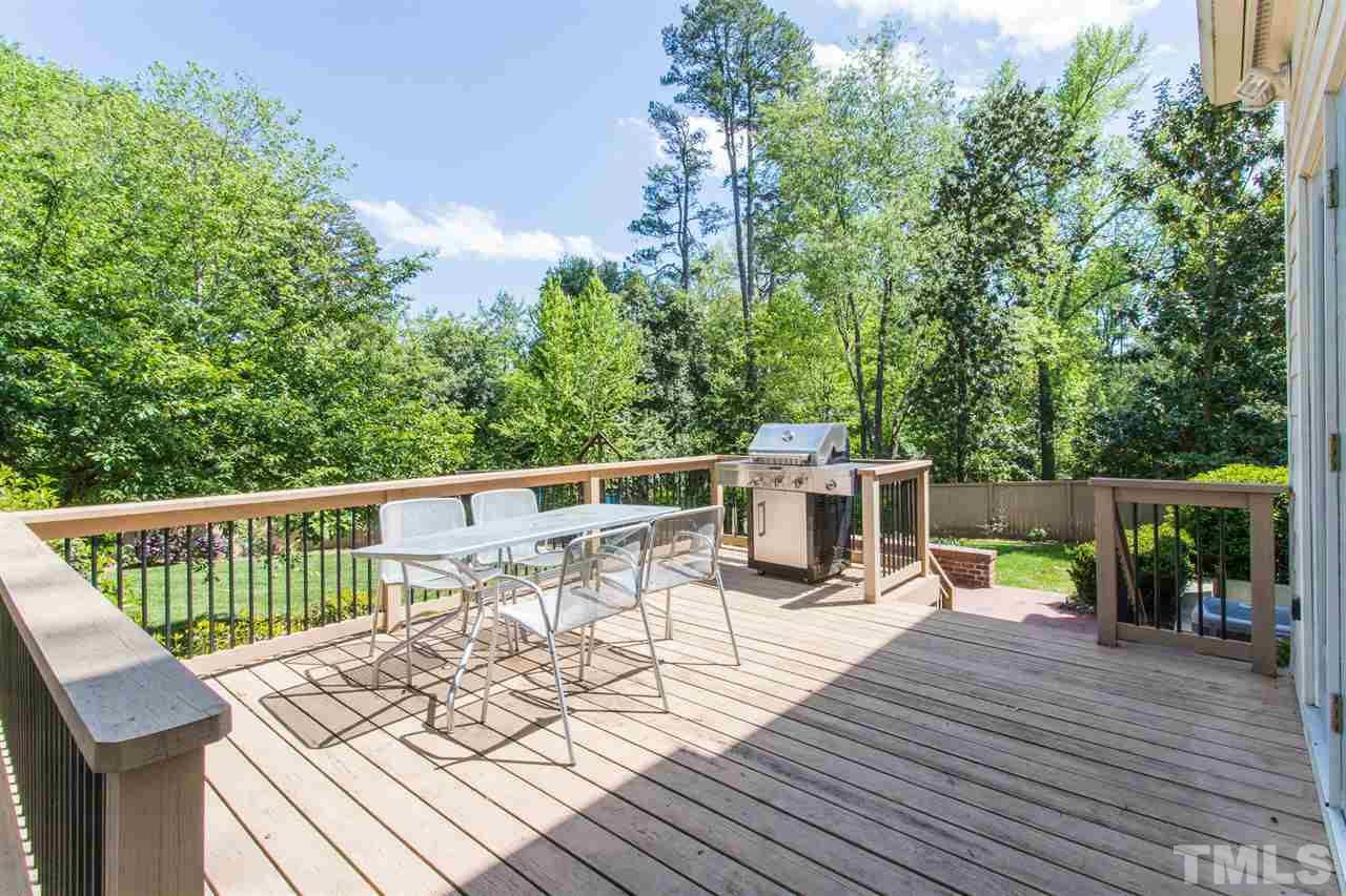 1424 Canterbury Road Raleigh, NC 27608 - Photo 26 of 29 a view of a deck with chairs a barbeque with wooden floor and fence